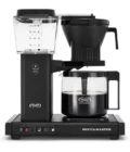 Front shot showing Moccamaster KBGV Select in Matte Black, with rectangular tower and base, clear acrylic water reservoir with fill level marks, power and volume selector switch, glass carafe with black handle, and black automatic brew basket.